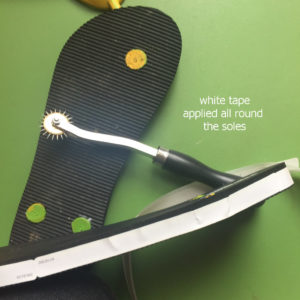 white tape applied around soles to make marking visible